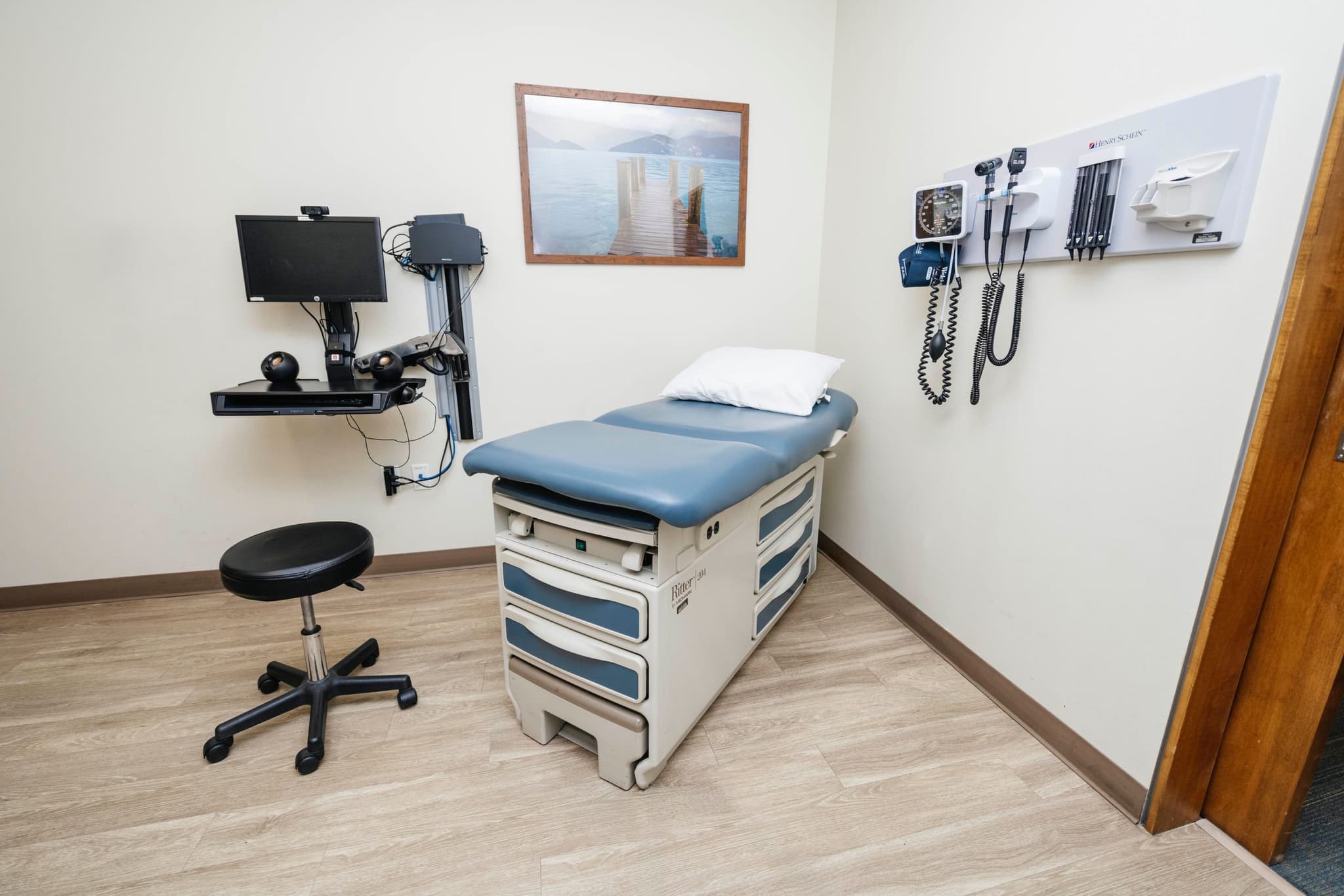 Image of Medical exam room equipped with an exam table, diagnostic tools, and seating for routine checkups and progress evaluations.