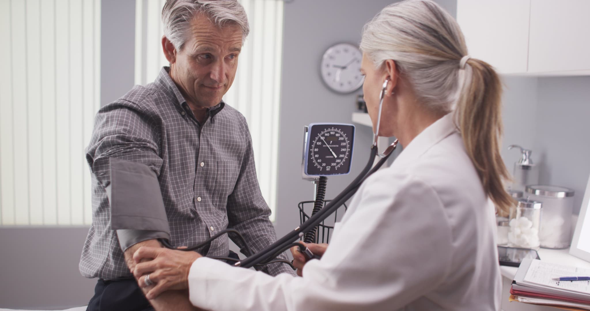 Picture of Professional doctor measuring senior man's blood pressure