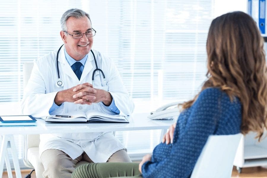 doctor talking to pregnant woman