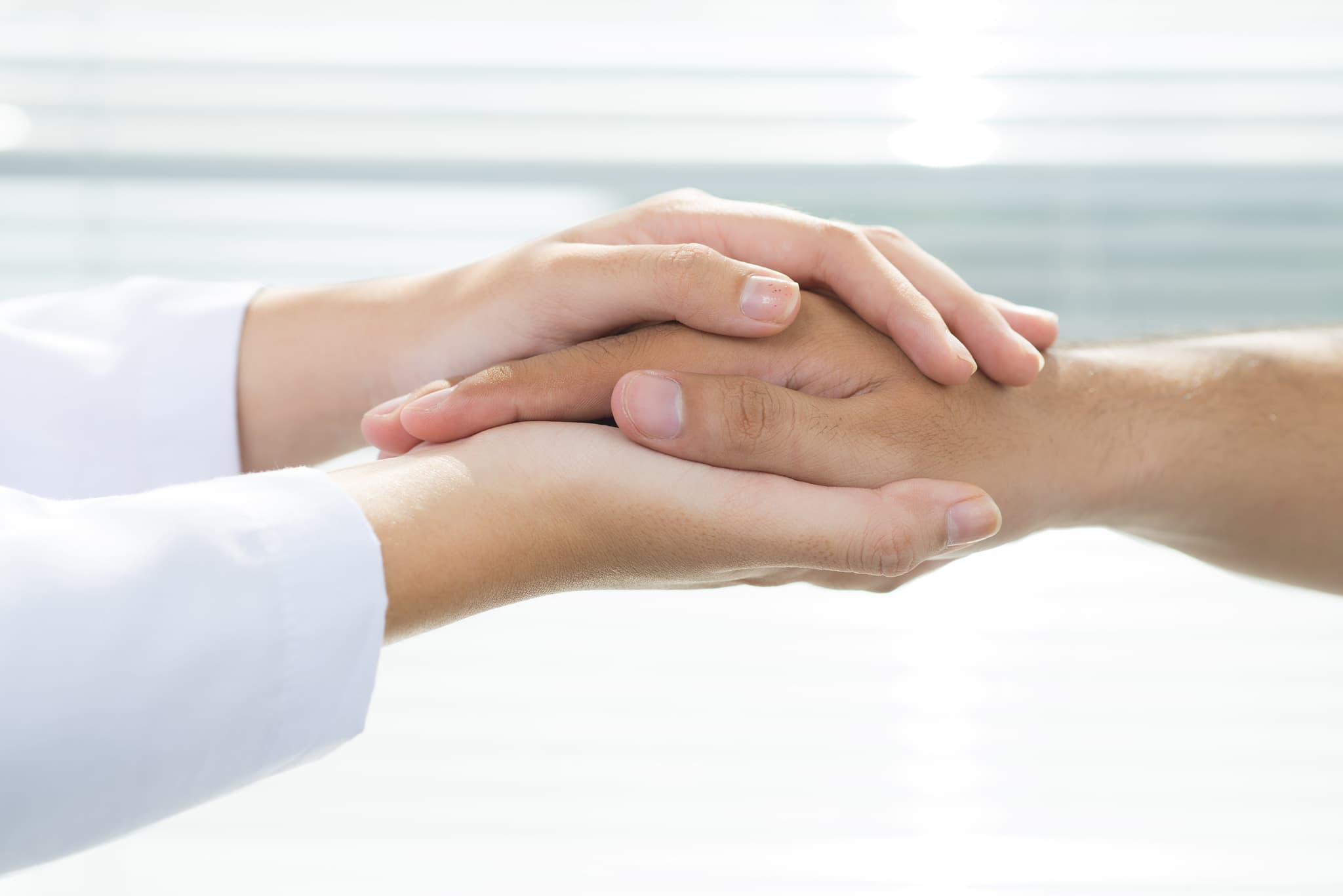 doctor holding patients hand