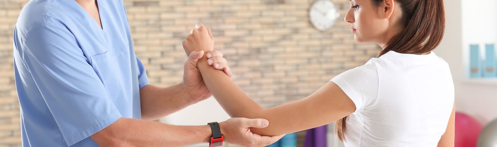 Picture of doctor helping woman with hand, wrist, elbow therapy