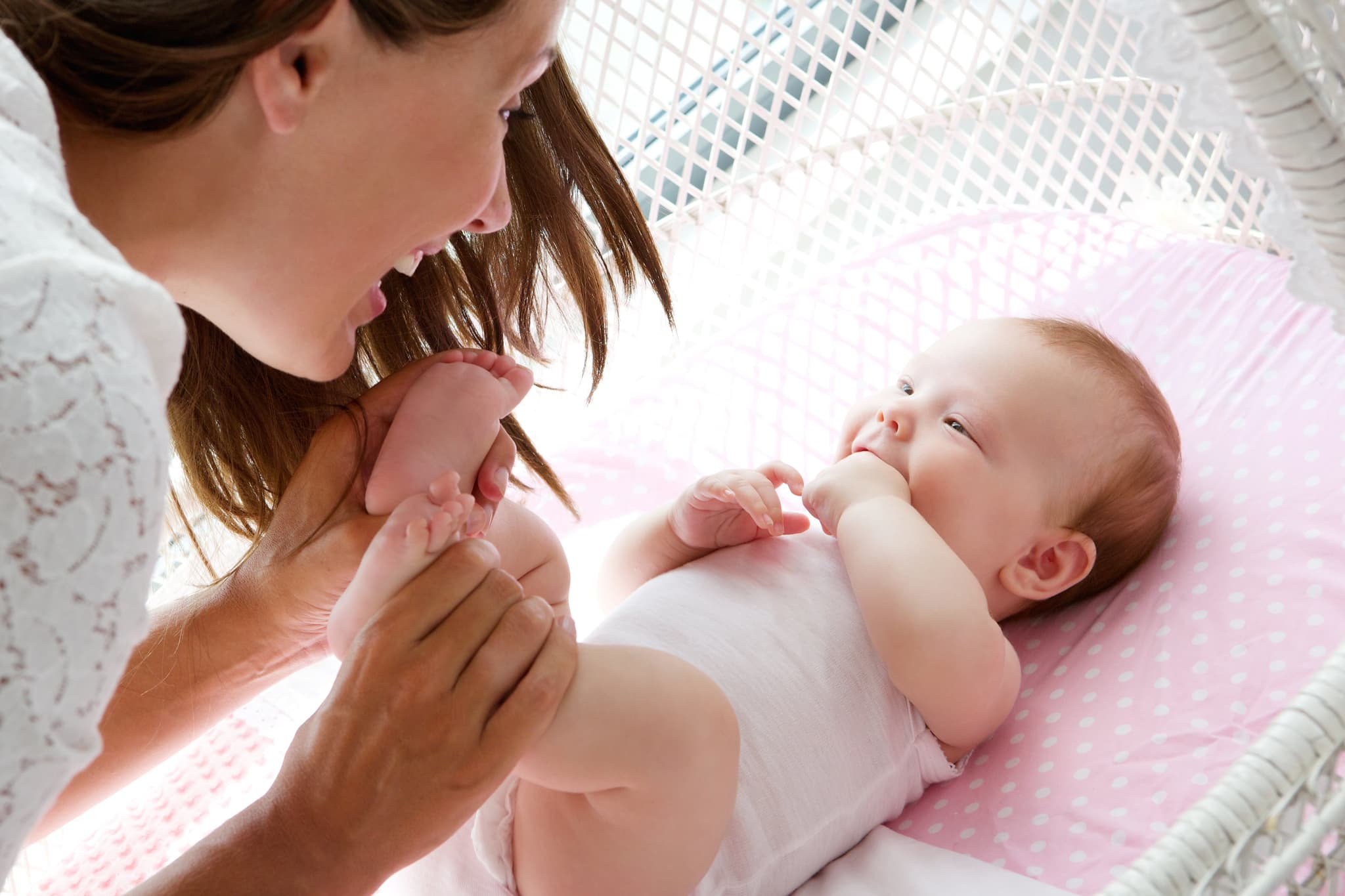Happy mother playing with cute baby
