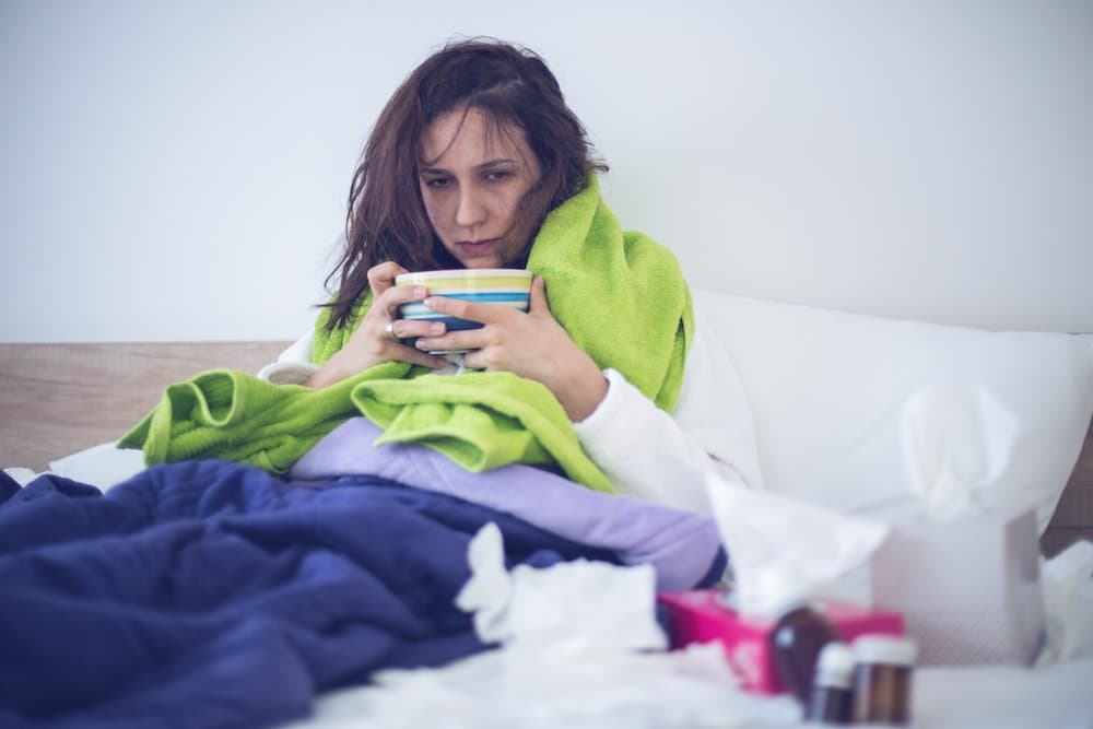 Picture of Eating chicken noodle soup in bed while sick