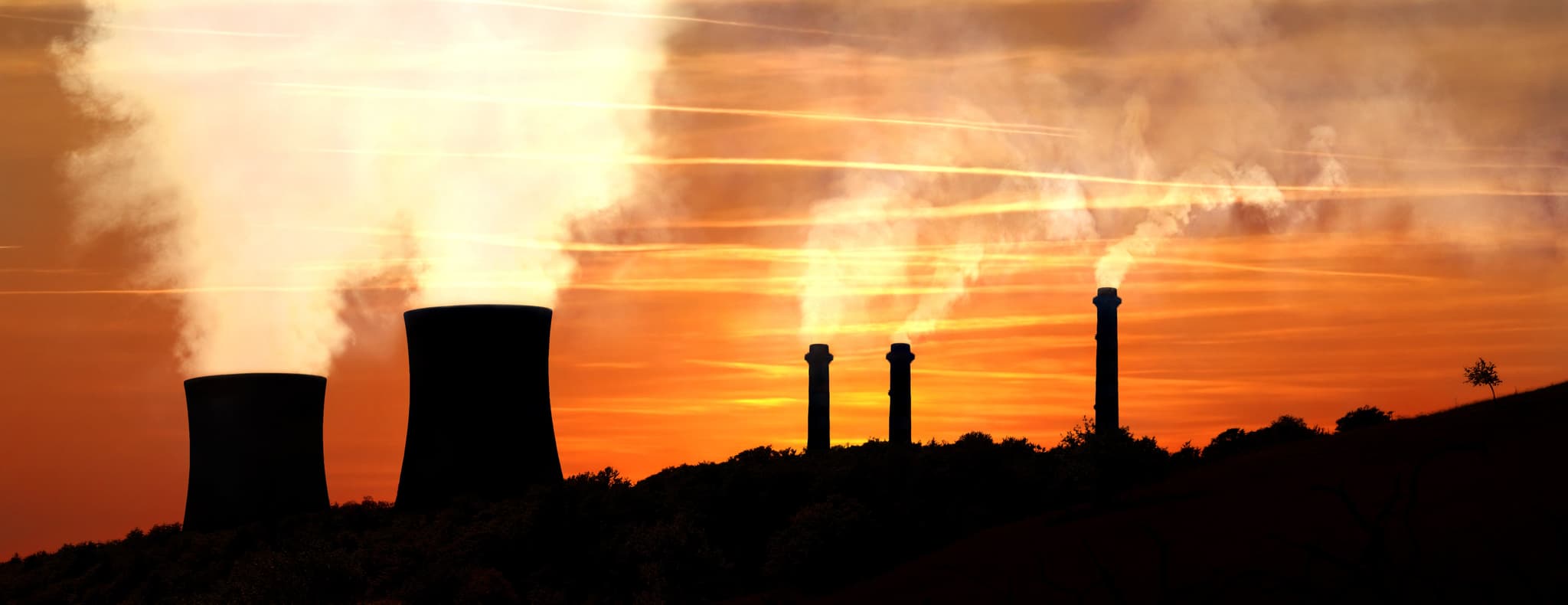 Picture of Power generating factories in the mountains at sunset backlight