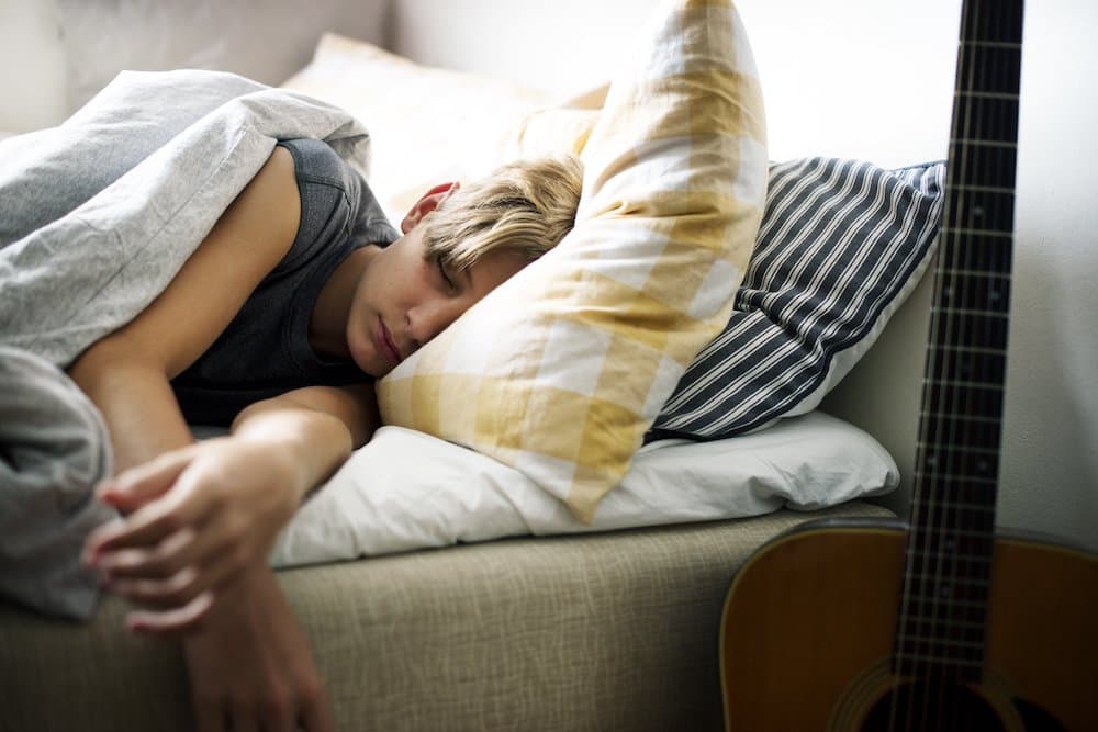 Picture of Young Caucasian boy sleeping in bed