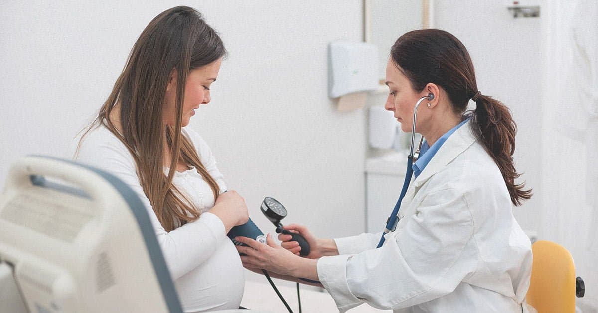 doctor taking blood pressure of Pregnant woman